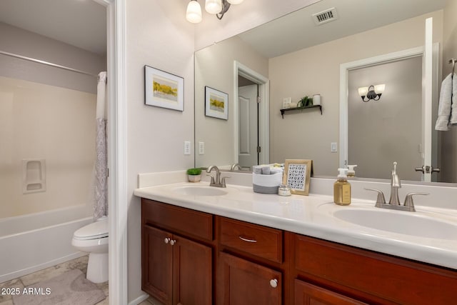 bathroom with double vanity, toilet, shower / bath combo, and a sink