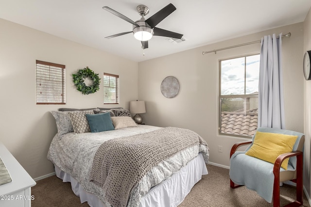 carpeted bedroom featuring multiple windows, baseboards, and visible vents