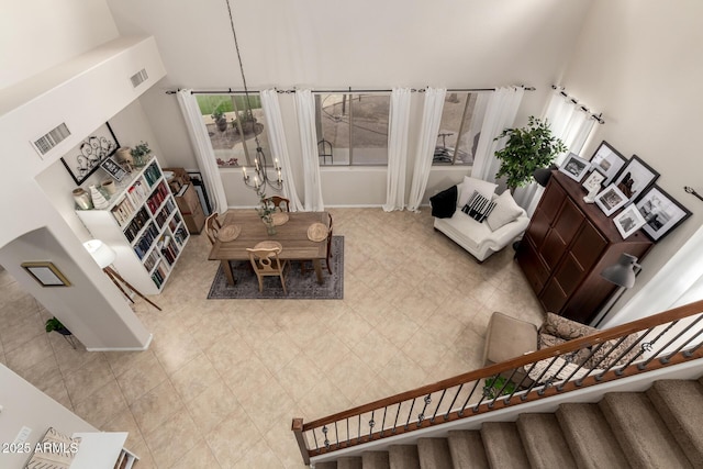 living area featuring visible vents, plenty of natural light, and stairs