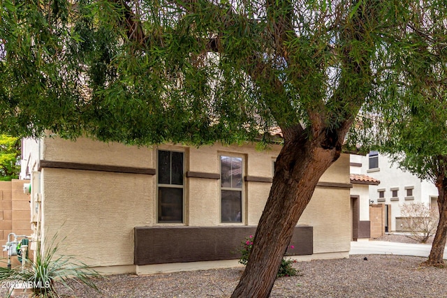 view of front of house with stucco siding and a tile roof