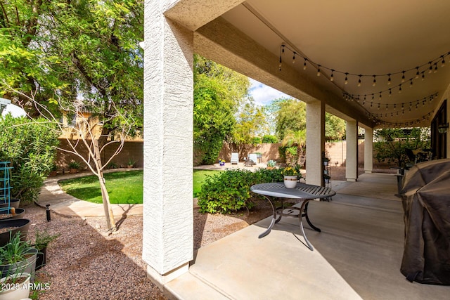 view of patio featuring a grill and a fenced backyard