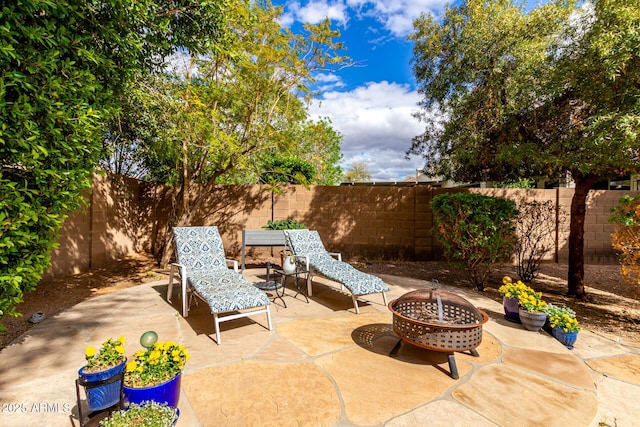 view of patio / terrace featuring a fire pit and a fenced backyard