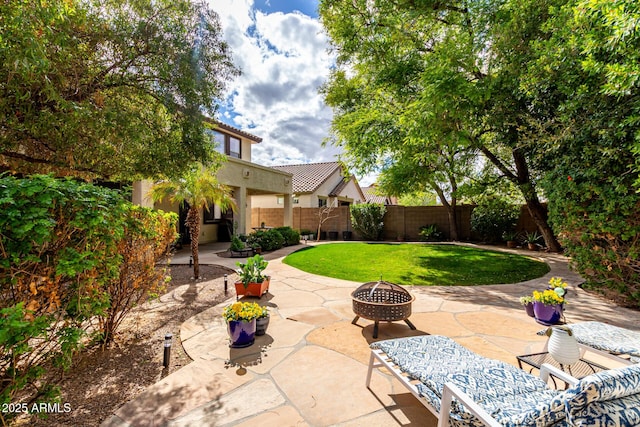 view of patio / terrace featuring fence and an outdoor fire pit