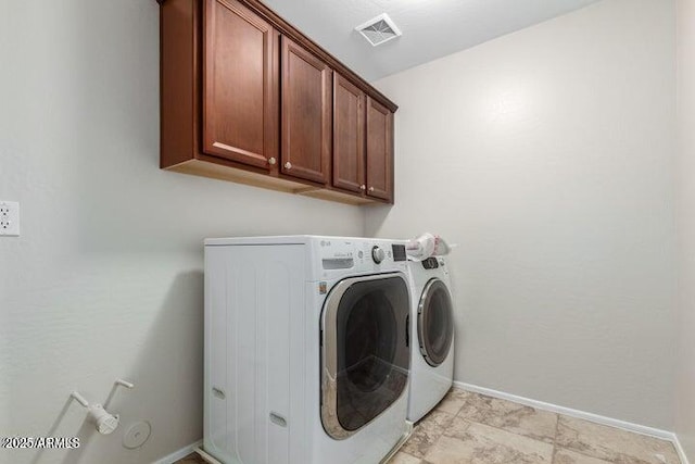 laundry area with visible vents, cabinet space, separate washer and dryer, and baseboards