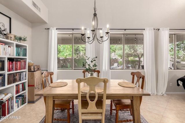 dining room with a notable chandelier, visible vents, and light tile patterned floors