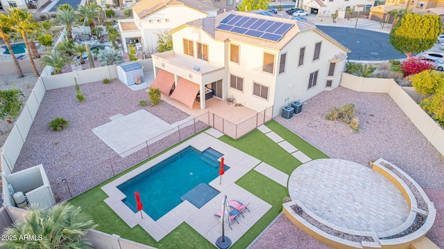 view of pool with central AC and a patio