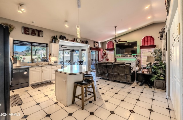 kitchen with ceiling fan, a kitchen island, vaulted ceiling, white cabinets, and black appliances