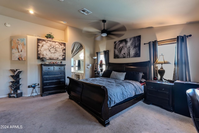 carpeted bedroom with ceiling fan and connected bathroom