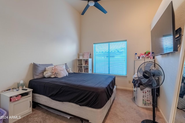 bedroom featuring ceiling fan, high vaulted ceiling, and light colored carpet