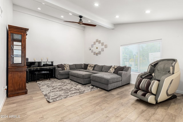 living room featuring vaulted ceiling with beams, ceiling fan, and light wood-type flooring