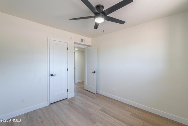 unfurnished bedroom with light wood-style floors, baseboards, ceiling fan, and visible vents