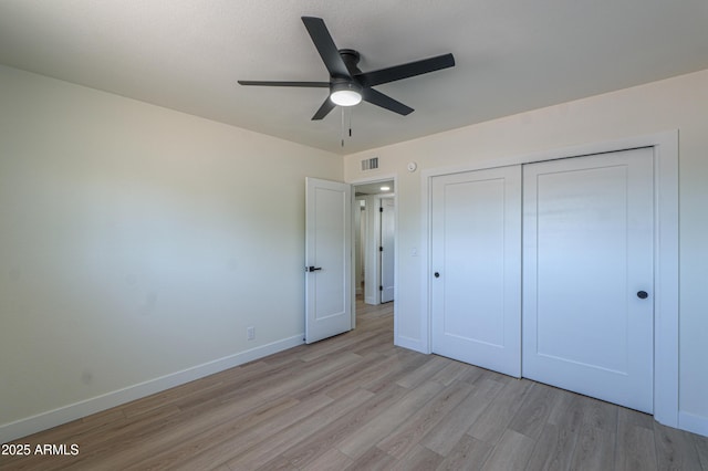 unfurnished bedroom with a ceiling fan, visible vents, baseboards, a closet, and light wood finished floors
