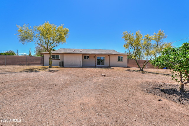rear view of house featuring a fenced backyard