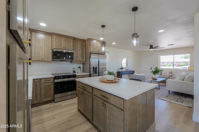 kitchen with light wood-style floors, recessed lighting, appliances with stainless steel finishes, and open floor plan