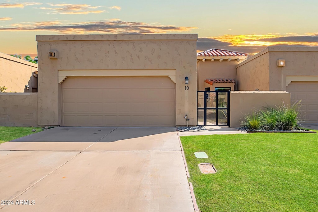 view of front of property with a lawn and a garage