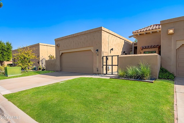 view of front of property featuring a front lawn and a garage