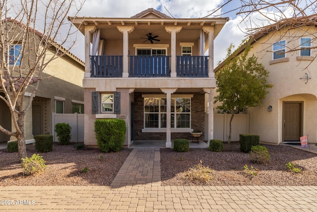 view of front facade featuring ceiling fan and a balcony