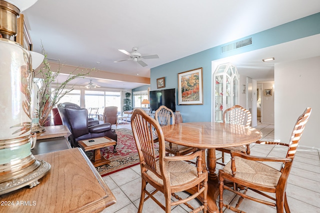 tiled dining room with ceiling fan