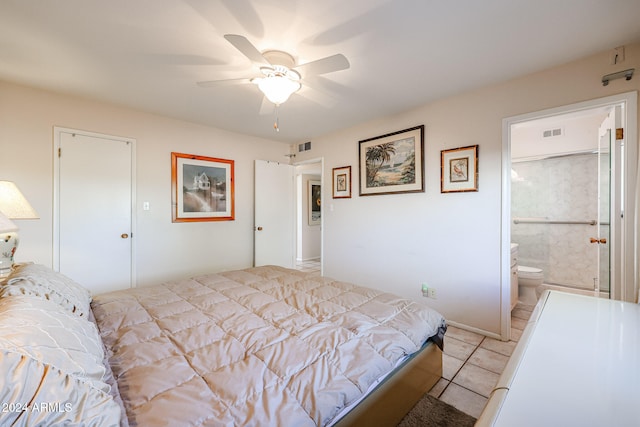 tiled bedroom with ensuite bath, ceiling fan, and a closet