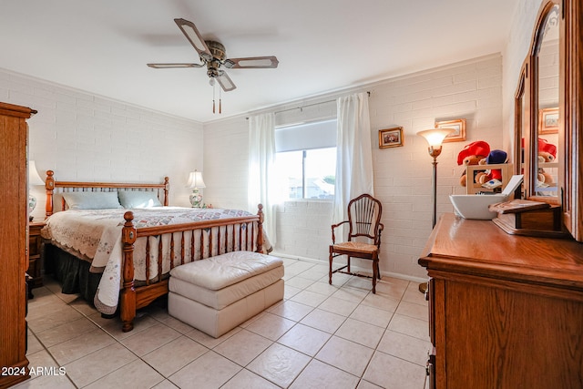 tiled bedroom featuring ceiling fan and brick wall