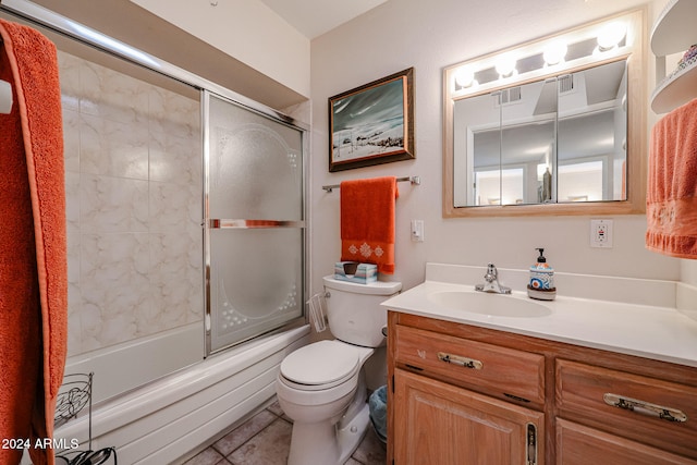 full bathroom featuring tile patterned flooring, vanity, bath / shower combo with glass door, and toilet