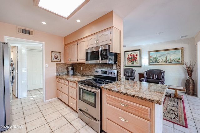 kitchen with light brown cabinets, backsplash, light tile patterned floors, light stone countertops, and appliances with stainless steel finishes