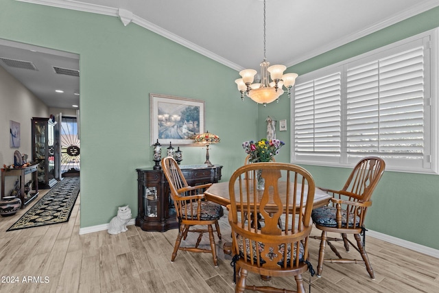 dining space featuring crown molding, vaulted ceiling, a chandelier, and light hardwood / wood-style floors