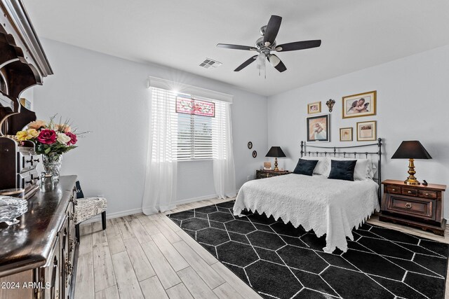 bedroom with ceiling fan and wood-type flooring