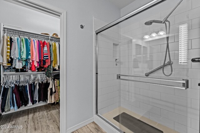 bathroom featuring hardwood / wood-style floors and an enclosed shower