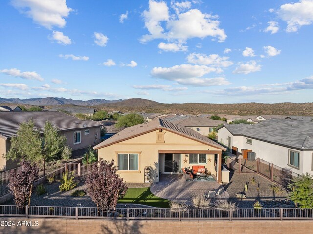 rear view of house featuring a mountain view and a patio