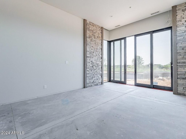 unfurnished room with concrete flooring