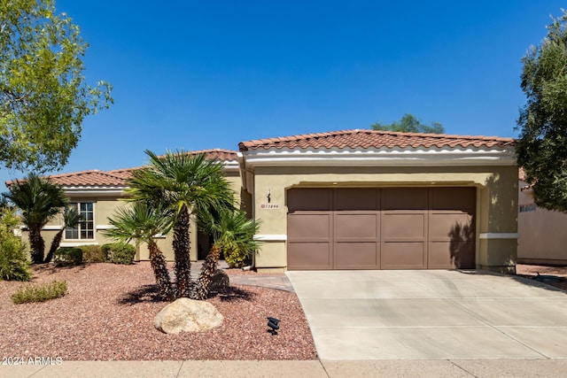 mediterranean / spanish home featuring a garage