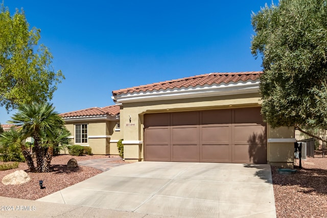 mediterranean / spanish home featuring a garage