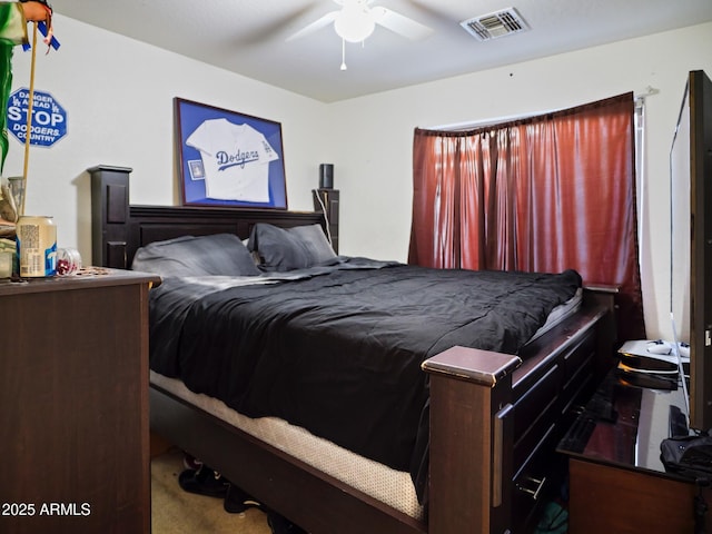 carpeted bedroom with a ceiling fan and visible vents