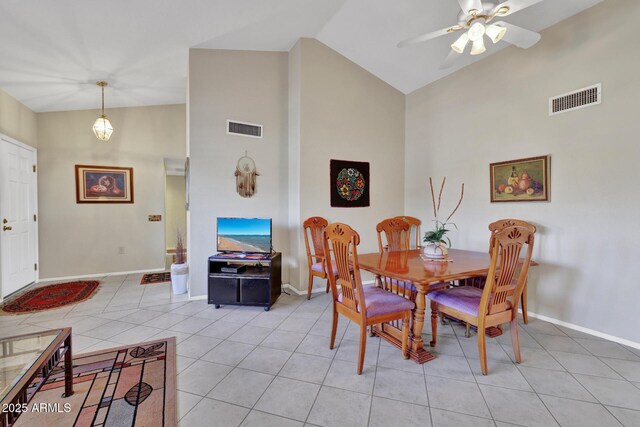 dining room with light tile patterned flooring, ceiling fan, and high vaulted ceiling