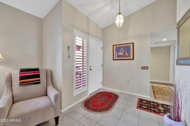 entryway featuring vaulted ceiling and light tile patterned floors