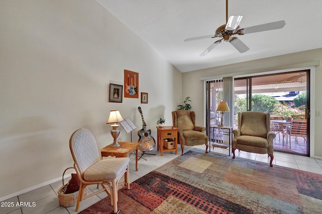 living area featuring light tile patterned flooring, vaulted ceiling, and ceiling fan