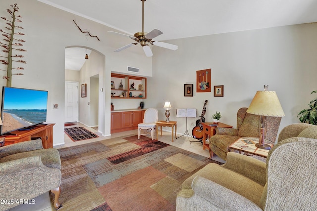 living room with ceiling fan, high vaulted ceiling, and light tile patterned floors