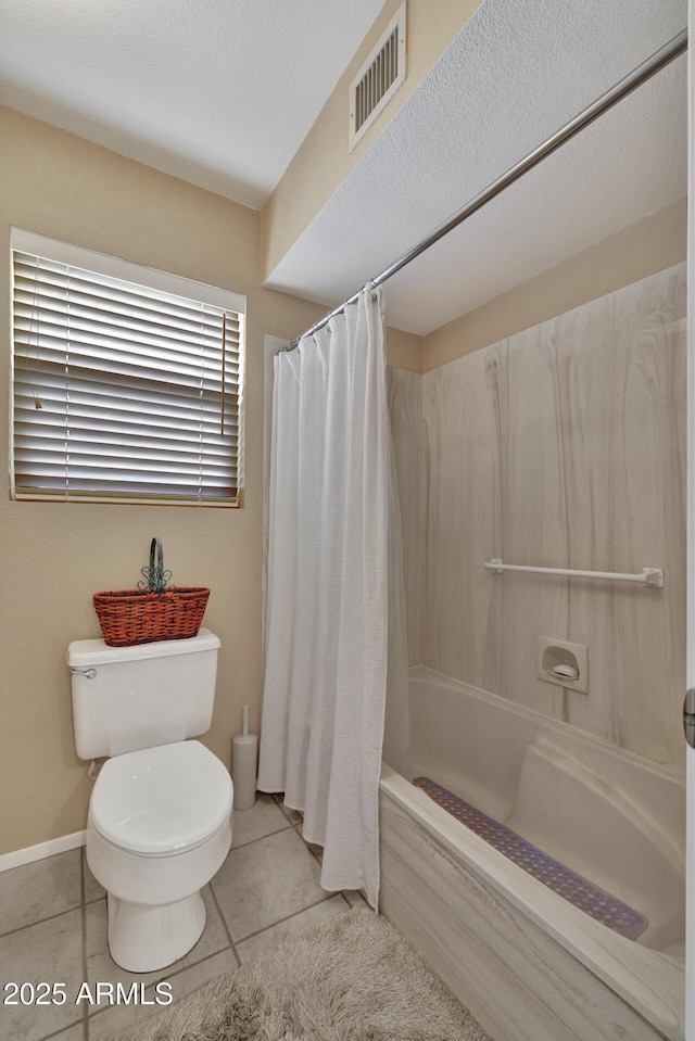 bathroom featuring toilet, tile patterned flooring, a textured ceiling, and shower / bath combo