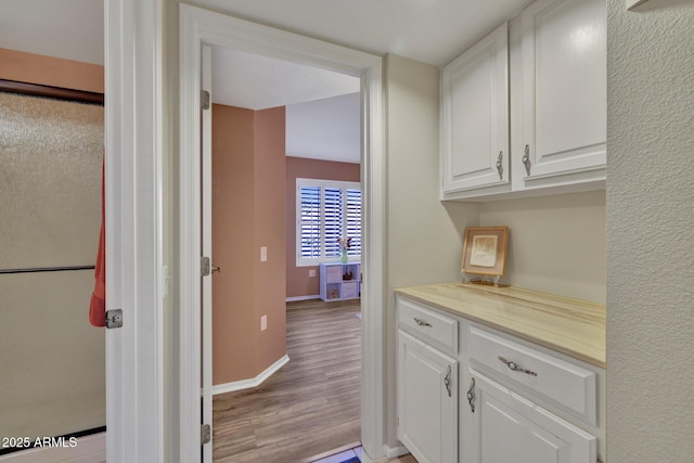 kitchen featuring light hardwood / wood-style floors and white cabinets