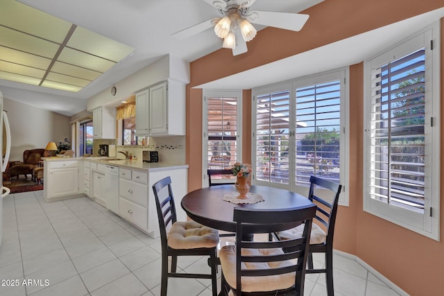 tiled dining room featuring ceiling fan