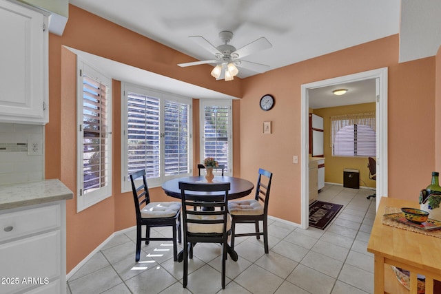 tiled dining area with ceiling fan