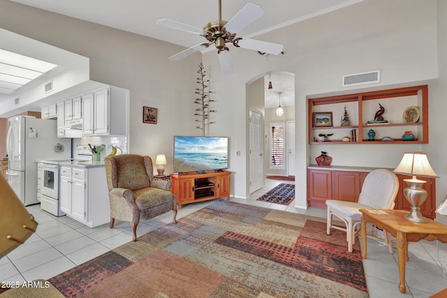 tiled living room with high vaulted ceiling and ceiling fan