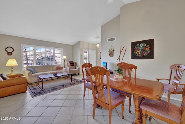 tiled dining area with high vaulted ceiling