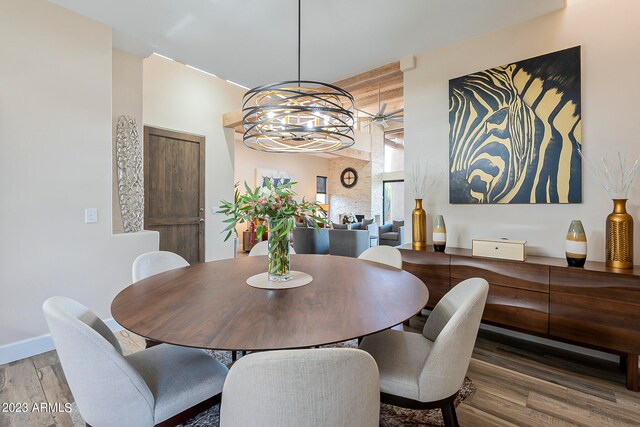 dining room with hardwood / wood-style floors and a chandelier