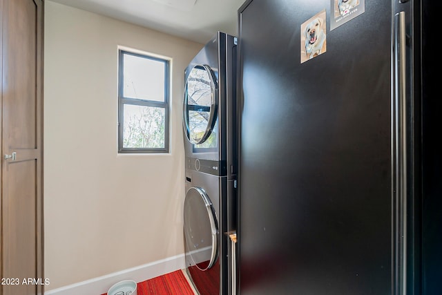 laundry room featuring stacked washer and clothes dryer