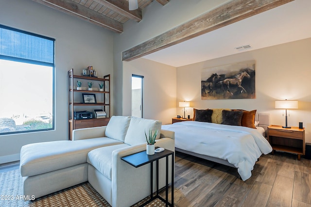 bedroom featuring beamed ceiling and dark hardwood / wood-style flooring