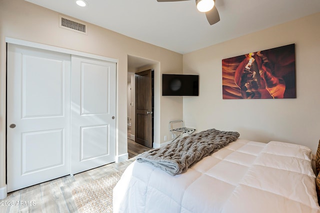 bedroom featuring a closet, ceiling fan, and hardwood / wood-style flooring