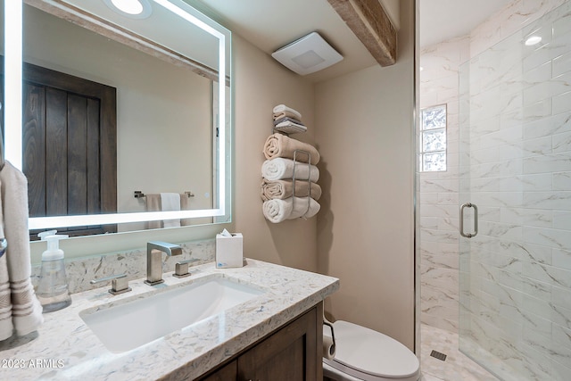 bathroom featuring vanity, toilet, and an enclosed shower