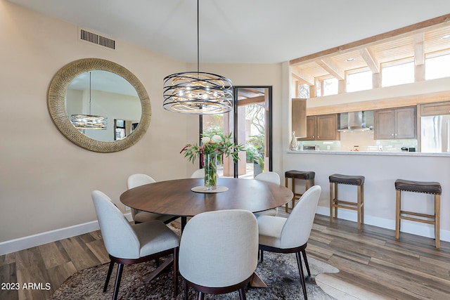 dining area featuring an inviting chandelier and dark hardwood / wood-style flooring